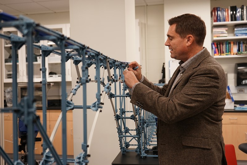 Christopher Ingemi works on a model of a bridge