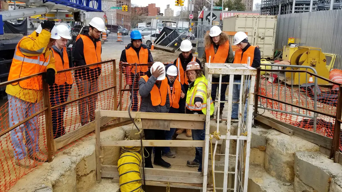 Students in UMass Lowell's civil engineering program look at a construction site