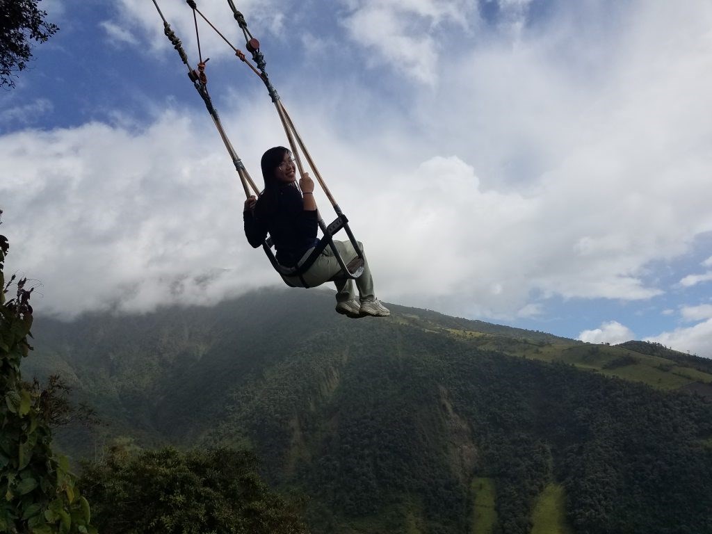 UMass Lowell study abroad on a forest cloud swing at Casa Del Arbol in Ecuador.