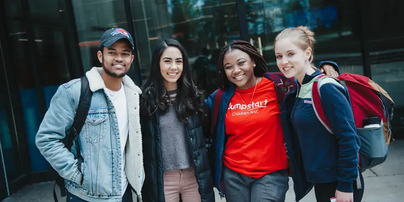 Four students in front of University Crossing