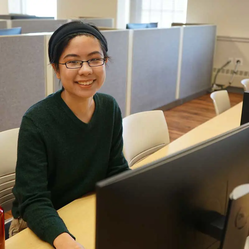Student working at a computer in a computer science lab at UMass Lowell