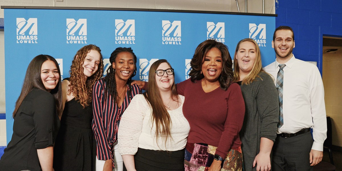 Coral Gonzalez poses for a photo with Oprah Winfrey and five other students who won Oprah Winfrey Scholarships in 2018