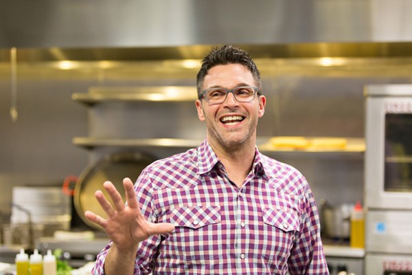 Mike Covino talking enthusiastically in one of his restaurant kitchens