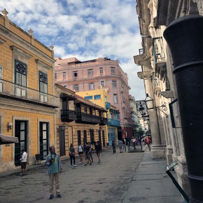 Street view picture from 2017-2018 UMass Lowell Winter Study Abroad trip to Cuba. This traveling seminar will use the Cuban experience as a backdrop for experiential learning, along with discussions with professionals in that particular field of study, and writing assignments designed to allow students to reflect upon their experience studying and living in Cuba. Students will gain a multi-disciplinary overview of Cuban contemporary culture. and further understanding from a cultural, socio-political and historical context.