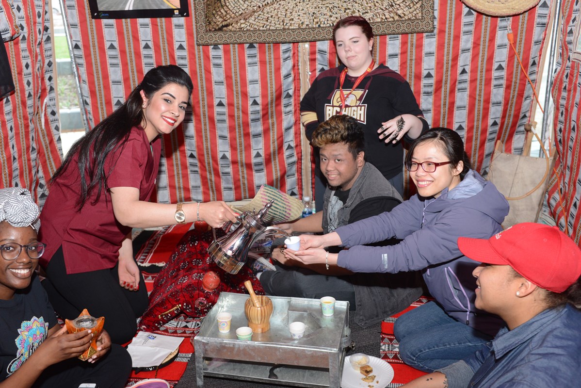 Students pour tea at the Cultural Carnivale where University Crossing was transformed as clubs and groups host a cultural experience of activities, games, performances, food, etc.