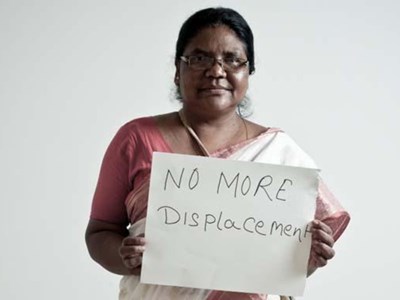 Dayamani Barla holding a sign saying No More Displacement