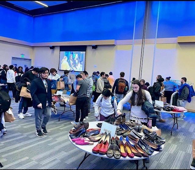 Moloney Ballroom filled with tables covered with shoes and clothing to giveaway