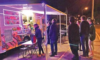 Students line up in the evening to get dinner at the Egyptian Food Truck
