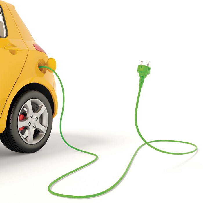 Photo illustration of a yellow electric car with wire and plug