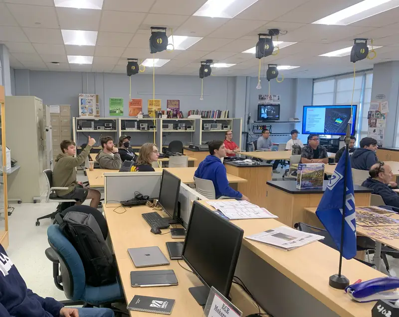 Seated students in the ECE Makerspace during a presentation