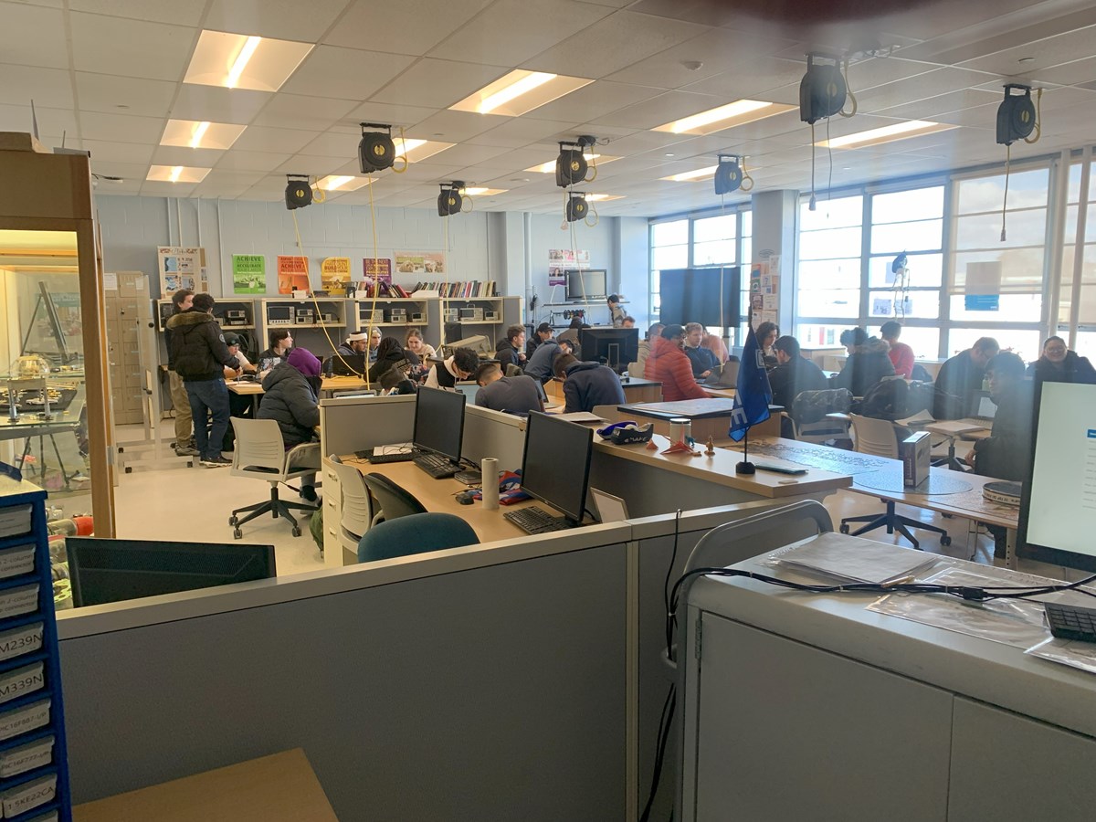 Large group of students working independently in the Makerspace