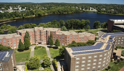 Summertime aerial view of East campus showing Donahue and Bourgeois residence halls, with the river and green trees in the background.