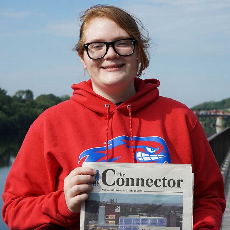 Brigid Archibald holds up copy of The Connector