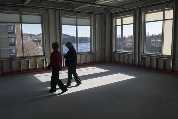 UMass Lowell Chancellor Jacqueline Moloney, left, and vice chancellor Patricia McCafferty walk through the Harbor Place 