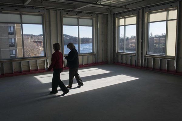 UMass Lowell Chancellor Jacqueline Moloney, left, and vice chancellor Patricia McCafferty walk through the Harbor Place 