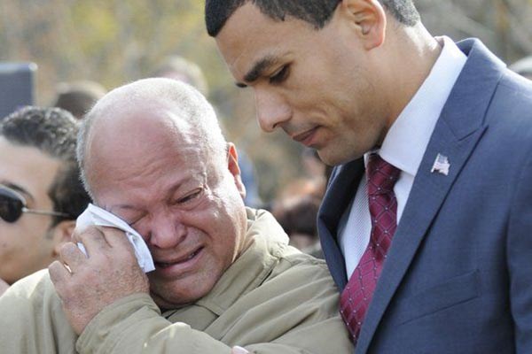ndy Jiminez, left, father of Alex Jiminez is comforted by former Lawrence veterans agent Francisco Urena.