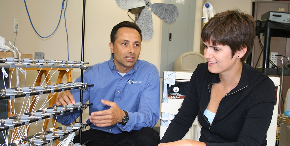 Mechanical Engineering professor Chris-Niezrecki showing equipment to a female student