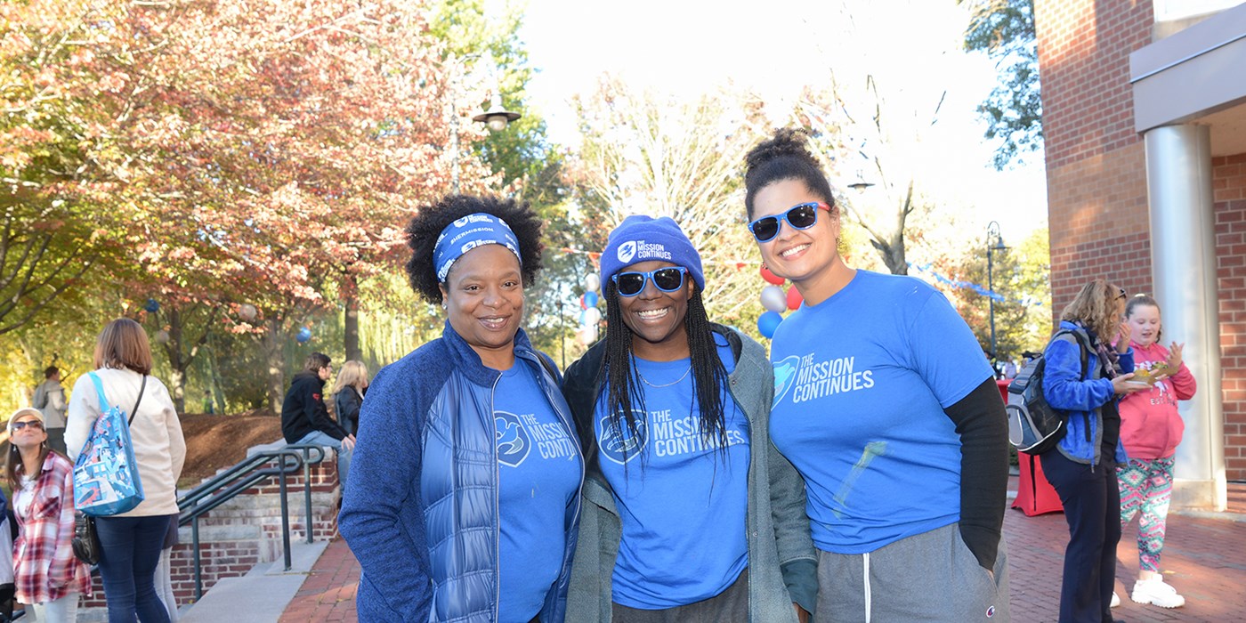 Student and family pose for a photo at festival, "The Mission Continues" at River Hawk Way Homecoming Festival on Saturday, October 19, 2019 at the Tsongas Center