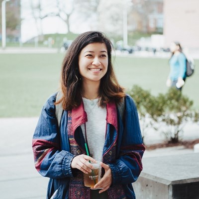 female student holding iced tea on south campus