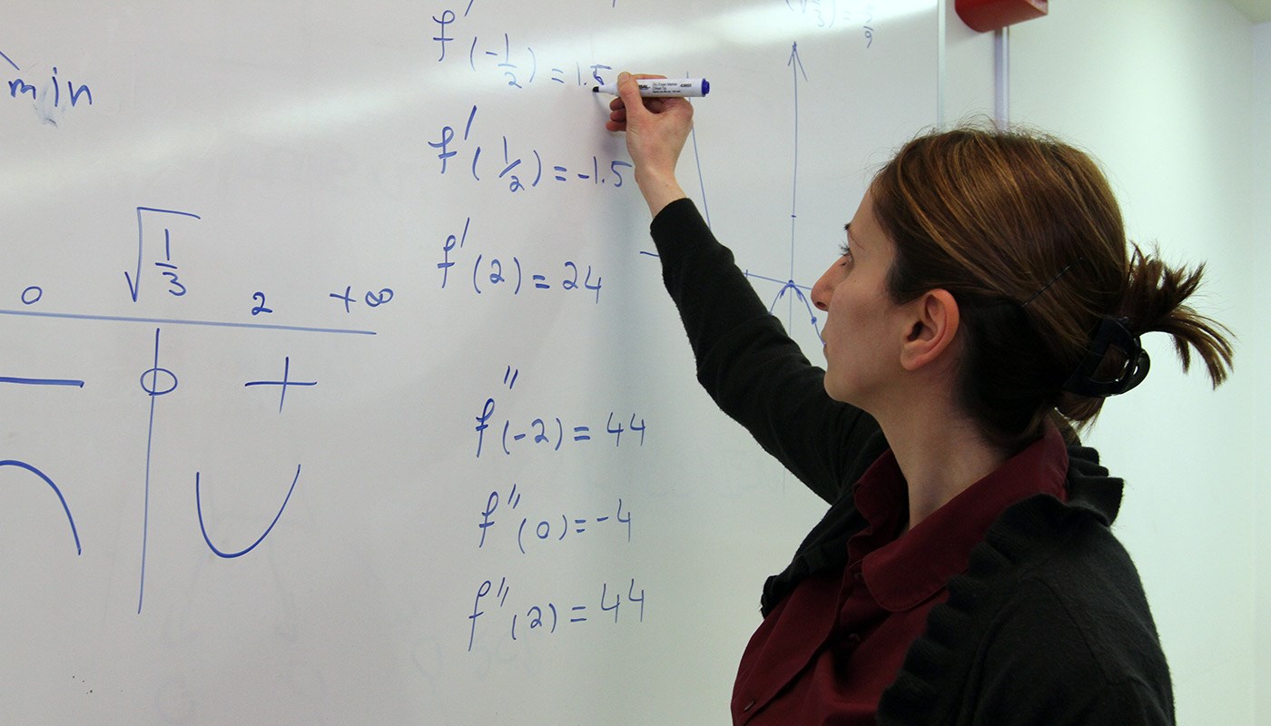 female-writing-equation-whiteboard