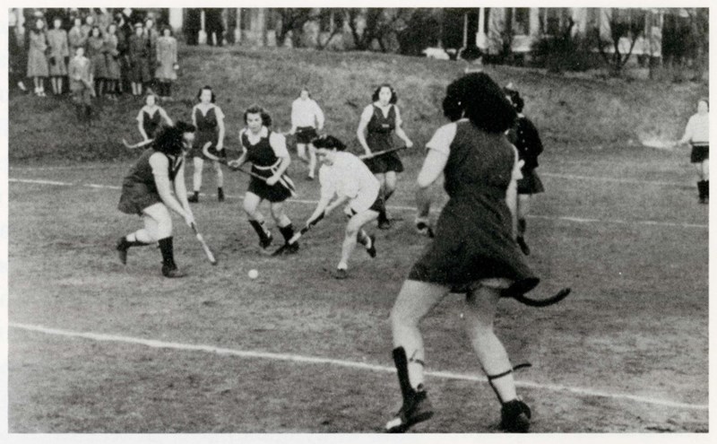 Female Teachers College students play field hockey in 1942