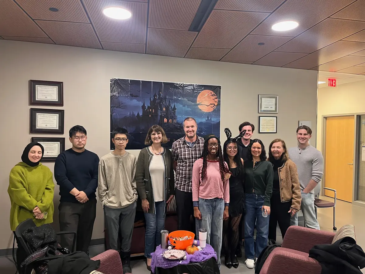Economics department students, staff and faculty pose during a Halloween party.