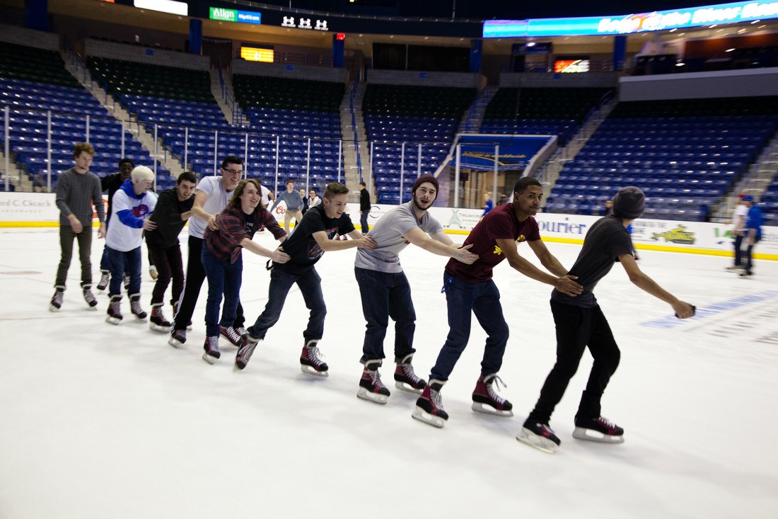 A group of skaters form a chain at the homecoming free skate at the Tsongas Center.