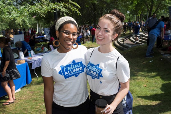 Two students check out UMass Lowell's Engagement Fair and BBQ after Convocation