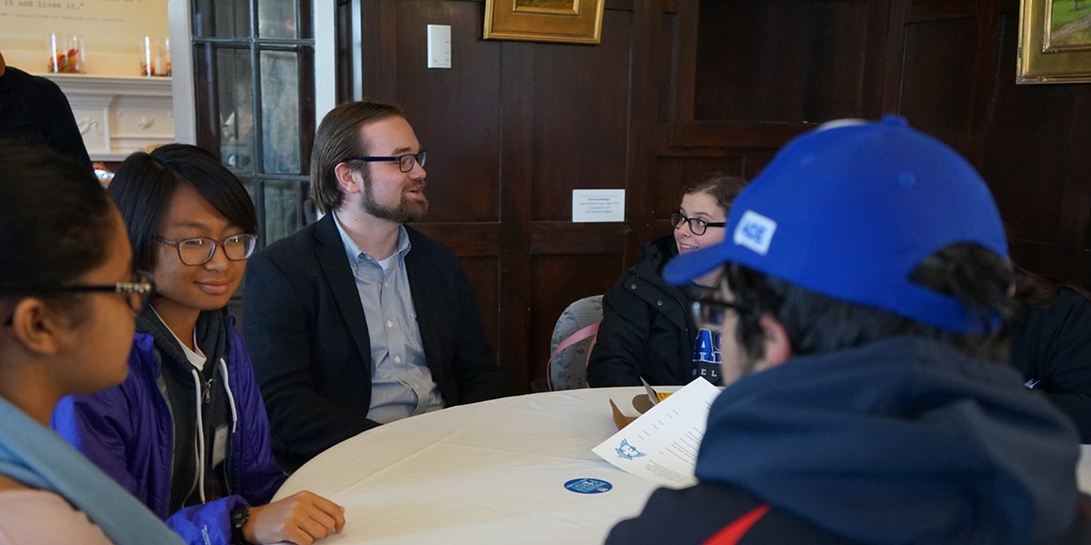 Gerrit Boldt sits at a round table with UMass Lowell students