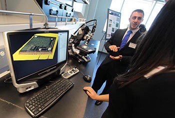 Kyle Homan, a doctoral student in electrical engineering, talked about printable electronics and nanotechnology at the opening of the Raytheon-University of Massachusetts Lowell Research Institute on Friday. Boston Globe photo by Mark Lorenz 