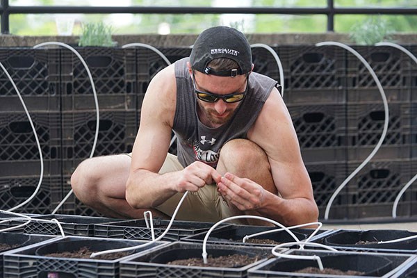 Austin Thoren helped plant the new container garden on a rooftop terrace at the O'Leary Library on South Campus.