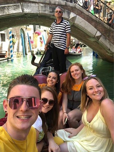 Group picture of UMass Lowell students on a gondola while explore Venice, Italy on a Study Abroad trip in the summer of 2018.