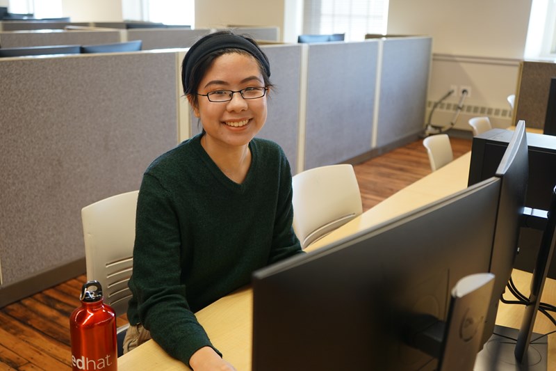 Grace Chin works at a computer on campus
