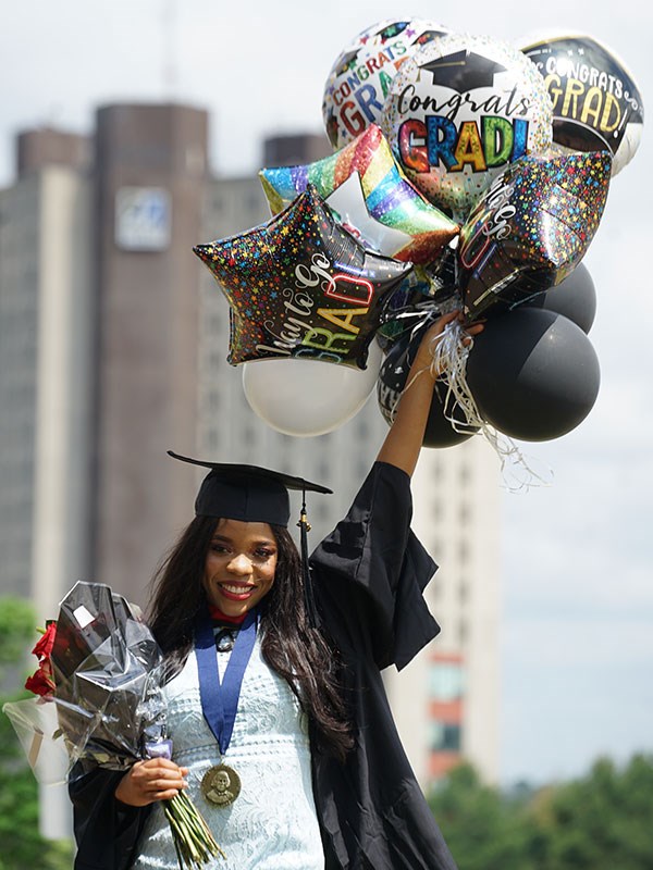 Graduate celebrates with balloons