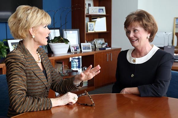 UMass Lowell Chancellor Jacqueline Moloney, right, talks with Herald columnist Judith Bowman about breaking the glass ceiling as a woman.