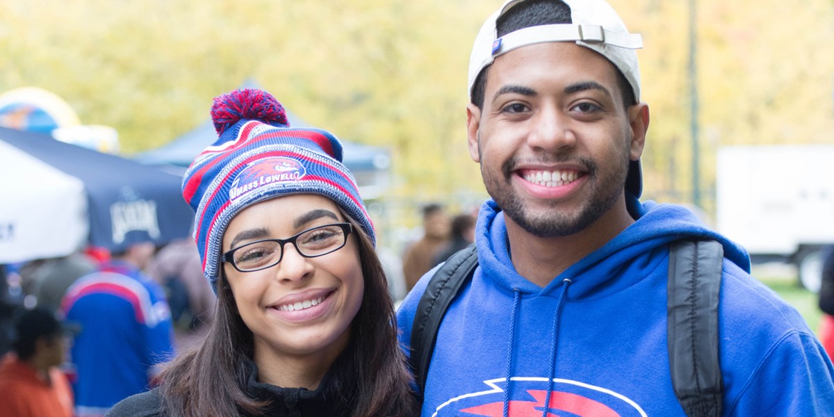 Two students decked out in their UML gear at one of the River Hawk Homecoming events