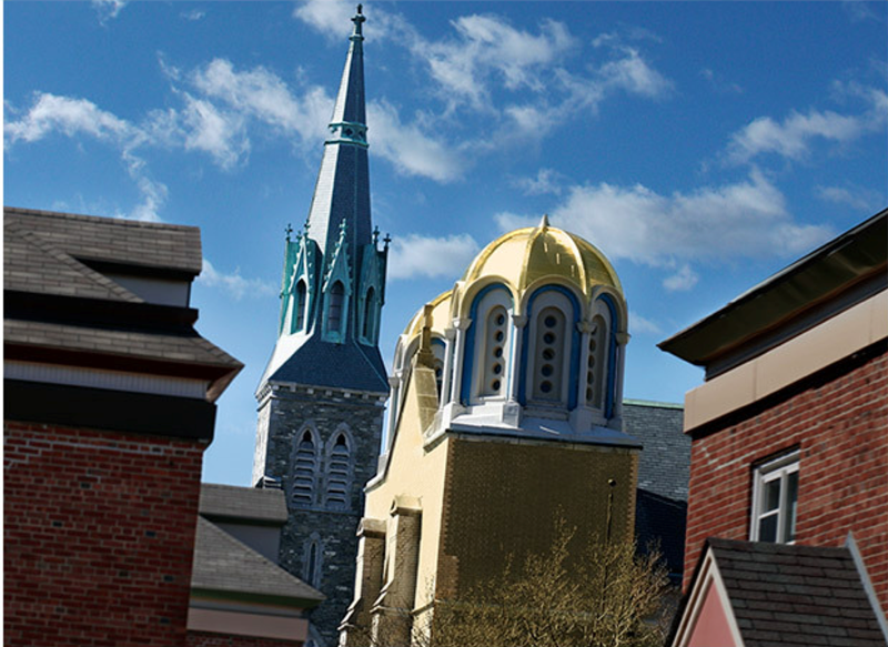 The spire of St. Patrick’s Church and the golden dome of the Holy Trinity Hellenic Orthodox Church in Lowell’s Acre section