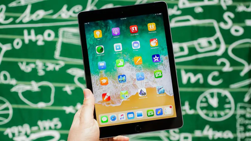 Held iPad showing home screen
