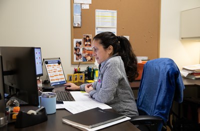 HR employee Maria Figueroa works at her desk