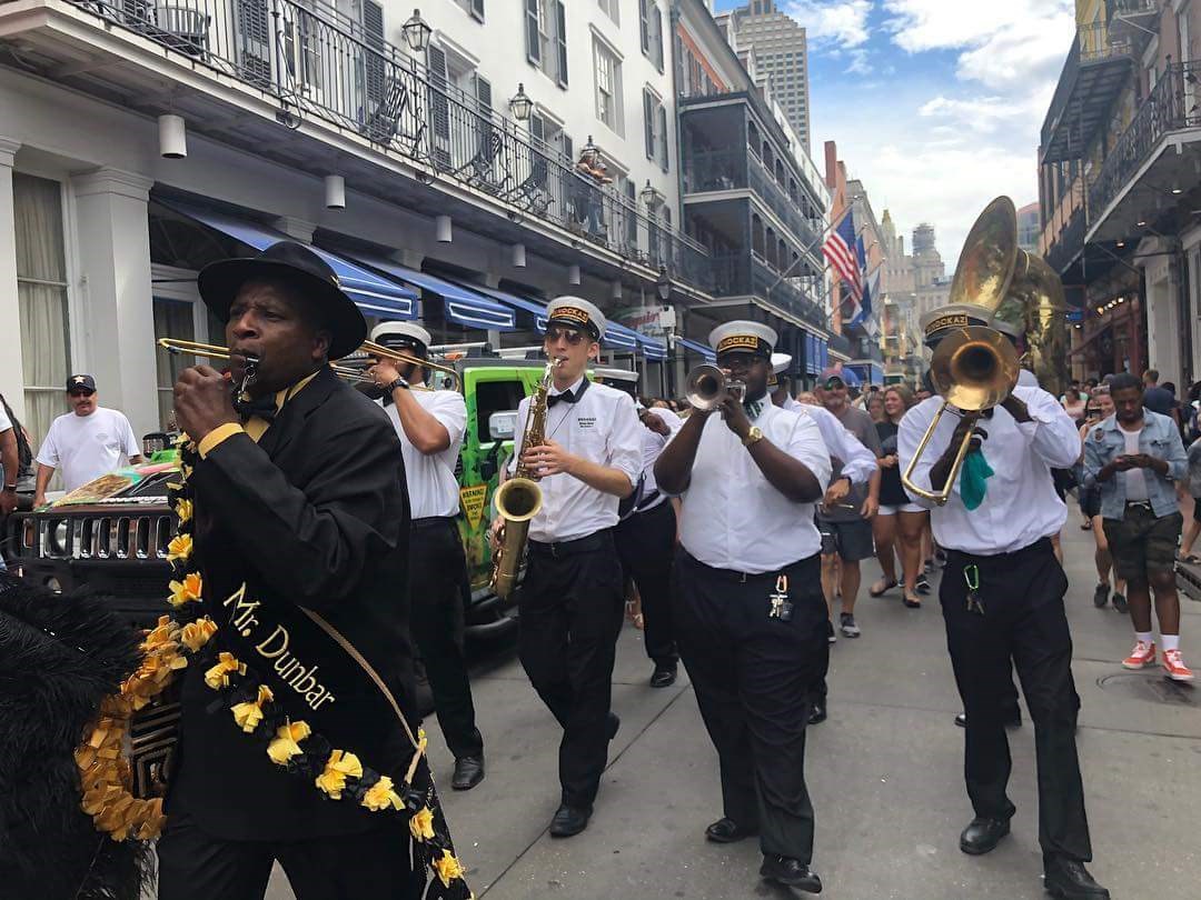 UML alum Seth Bailin (third musician from right) honks his sax way down in New Orleans with one of the street bands he play with, Knockaz, in the French Quarter. 