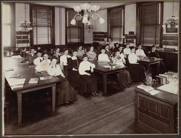 Female students seated at desks in classroom at Lowell Normal School in the 1900s