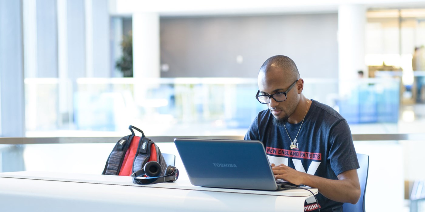 Man sitting at laptop in University Crossing