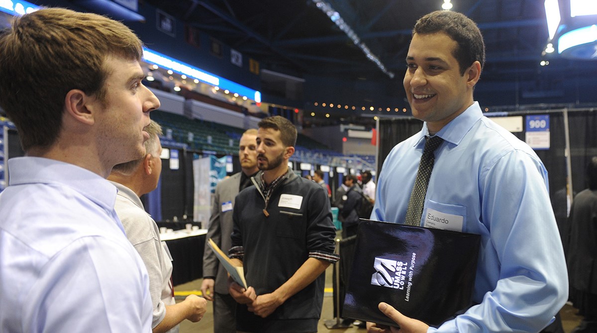 A student interacts with employers at the Career & Co-op Center's Career Fair at the Tsongas Center.