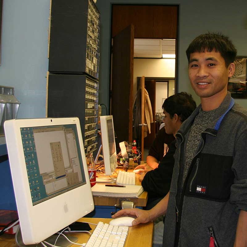 Student standing in computer lab at UMass Lowell
