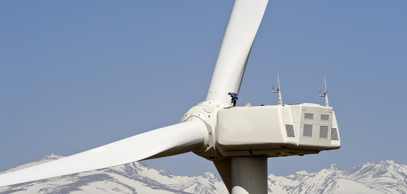 man-working-on-gigantic-wind-turbine