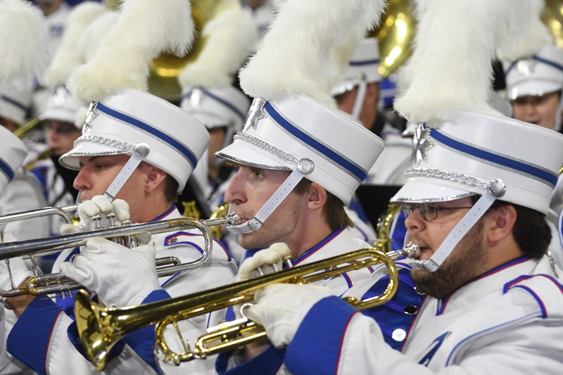 UMass Lowell marching band members play trumpets