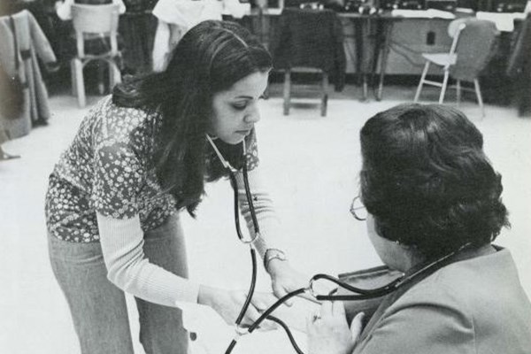 Marian Dubrule checks a patient's blood pressure in 1975.