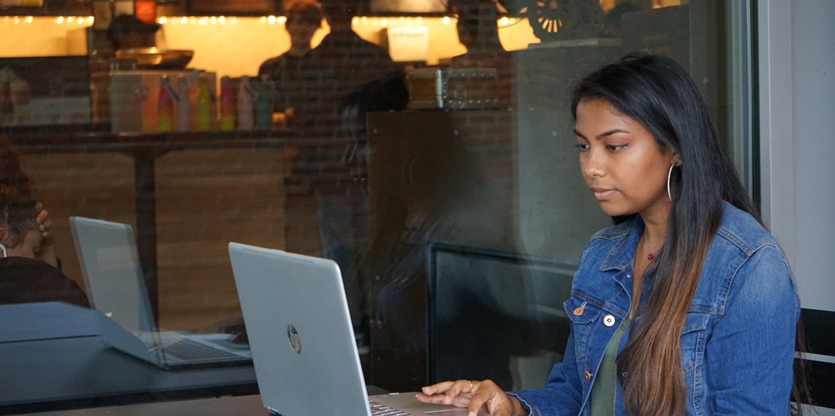 Marilyn Saha works on her laptop outside of Starbucks on South Campus