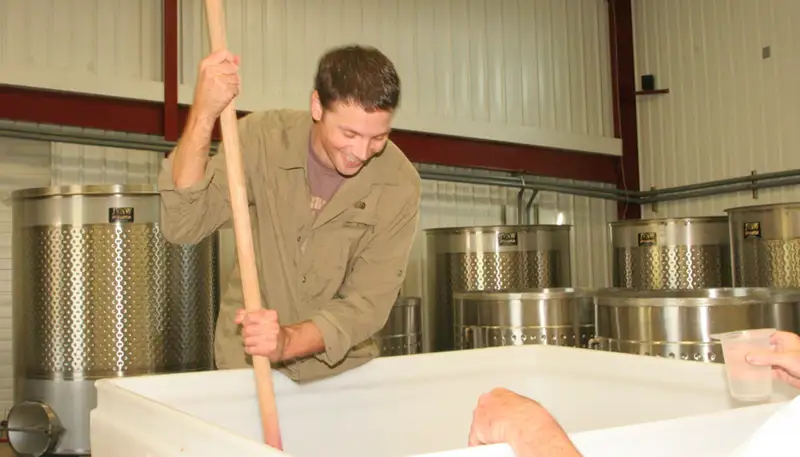 Mark Proden works with grapes at the Portland Wine Bar