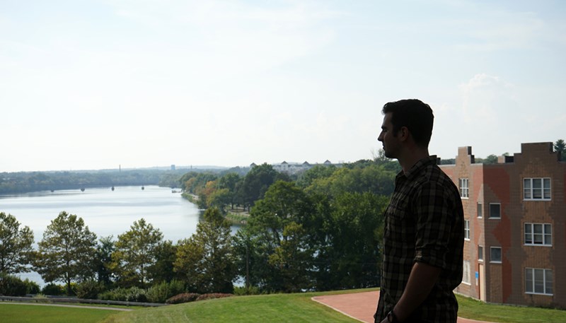 Matt Cherkerzian looks over the Merrimack River on UMass Lowell's South Campus